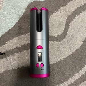 Automatic hair curler. Put a piece of hair in the barrel and it does it for you!